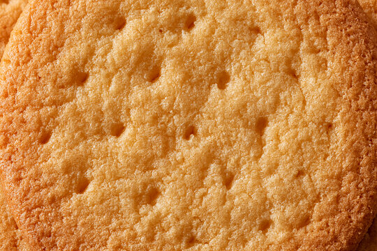 Golden butter cookie texture in extreme close-up