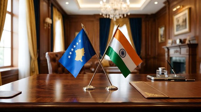 Kosovo and India table flags on wooden desk, representing international diplomacy and cooperation