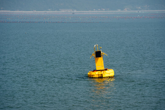 Yellow Navigation Buoy Floating on Open Blue Water