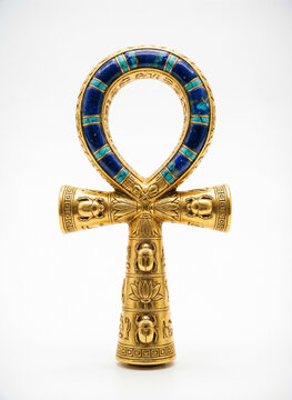 ancient Egyptian ankh symbol in polished gold on white