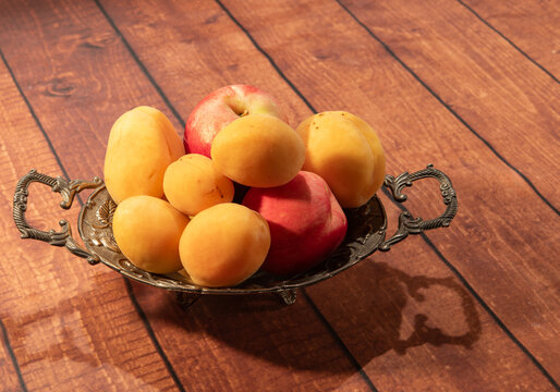 Closeup of nectarine and apricot in a vase