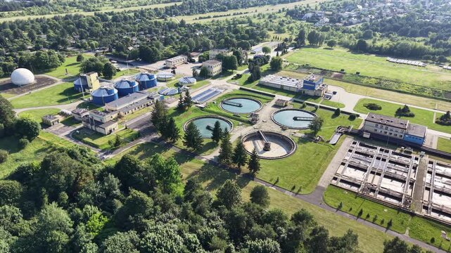 Modern water treatment facility with circular settling tanks from above