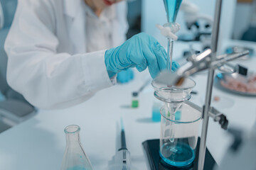 Fototapeta premium Biomedical scientists conduct laboratory experiments using microscopes, laboratory glassware, and biological samples to support medical research, diagnostics, biotechnology, and healthcare innovation.