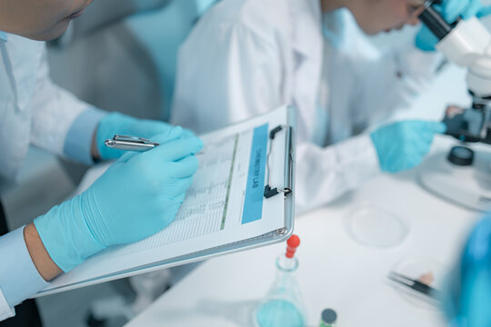 Biomedical scientists perform laboratory experiments using microscopes, laboratory glassware, and biological samples while recording results to support medical research, diagnostics and biotechnology.