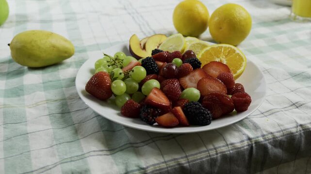 Medium dolly shot across fresh fruit on plate