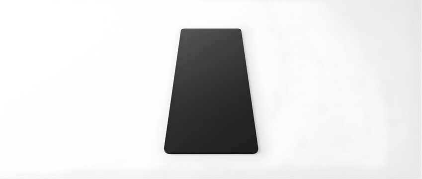 A stark black trapezoid shape centered on a clean white background with sharp lighting creating subtle shadows emphasizing its three dimensional form