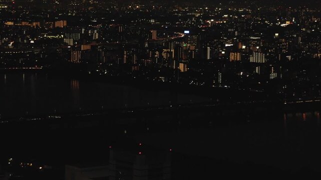 Osaka Cityscape At Night View From The Umeda Sky Building In Japan. POV Wide Shot
