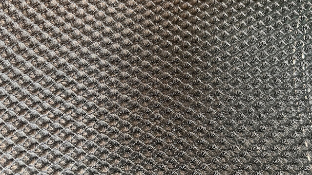 Black ventilation mesh with a honeycomb-like perforated weave structure to help increase airflow and reduce humidity