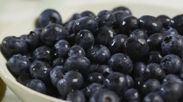 Smooth panning shot across blueberries, strawberries, peaches and grapes