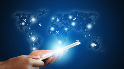 Travel booking through a smartphone showing a digital world map with flight routes and icons © fotofabrika