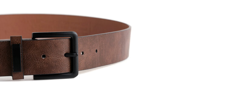 Macro shot brown leather belt with black metal buckle isolated on clean white background.