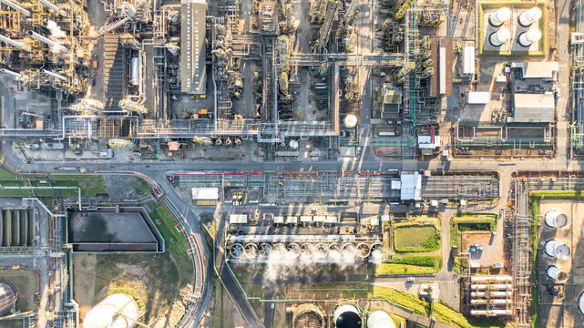 Aerial view of a large petrochemical complex with intricate piping networks, industrial storage tanks, cooling towers emitting steam, and processing units in Santo Andre, State of Sao Paulo, Brazil.