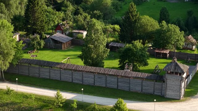 Aerial view of the wooden Voruta castle replica surrounded by lush green trees and grassy fields in Anyksciai, Utenos apskritis, Lithuania.