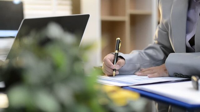 Car sale or rental concept, Closeup Dealership manager signing car insurance document or lease paper contract. Customer with car dealer agent making deal, sign on agreement document contract in office