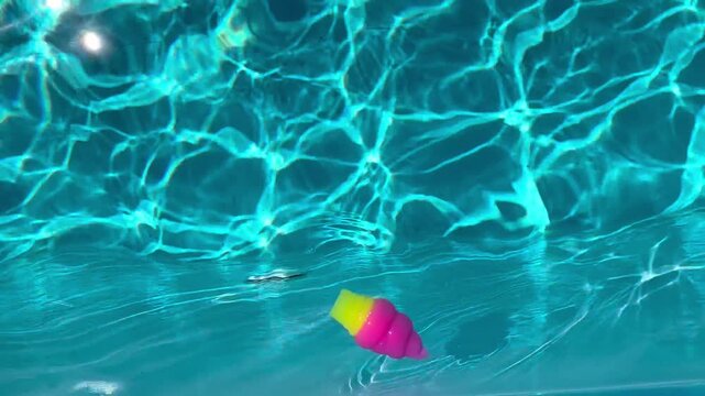 Ice cream squishy toy floating in a swimming pool