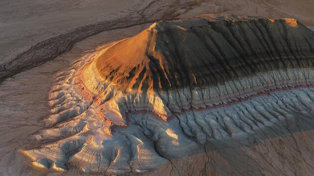 Aerial view of Gora Bokty showcasing layered sedimentary rock formations and desert terrain in Karakiya District, Mangystau Region, Kazakhstan.