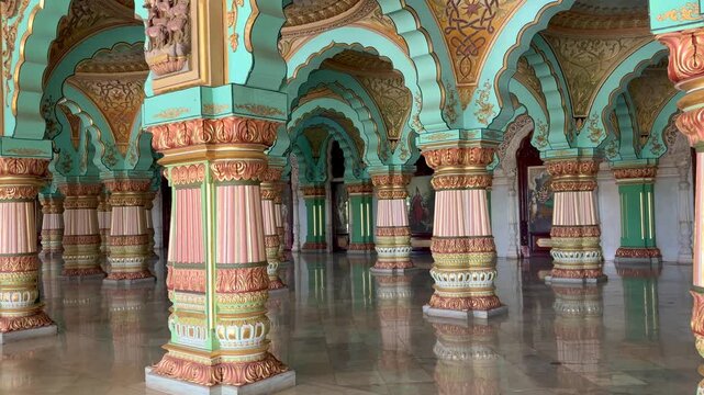Ornately decorated pillars and arches inside Mysore Palace in Mysuru, Karnataka, India, showcasing the grandeur of Indo-Saracenic architecture and royal heritage
