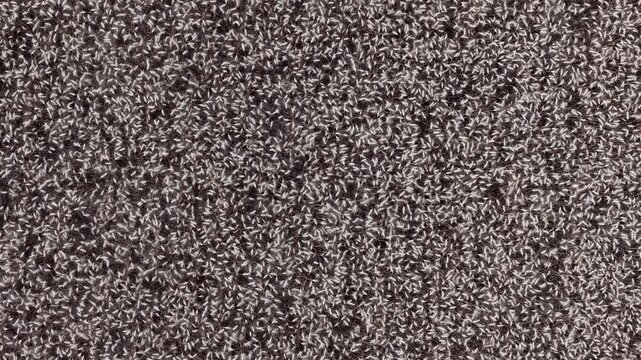 A detailed close-up shot of a thick knitted fabric showing intricate woven fiber patterns with a warm, cozy textile aesthetic.