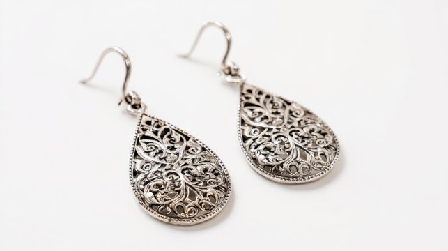 Sophisticated silver filigree earrings with intricate floral pattern isolated on white background, elegant vintage jewelry accessory, handmade ornamental design, luxury fashion earrings for women, cla