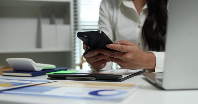 Business professional reviewing financial reports, analyzing business performance, calculating budgets and managing office documents with digital devices for accounting, finance and corporate planning