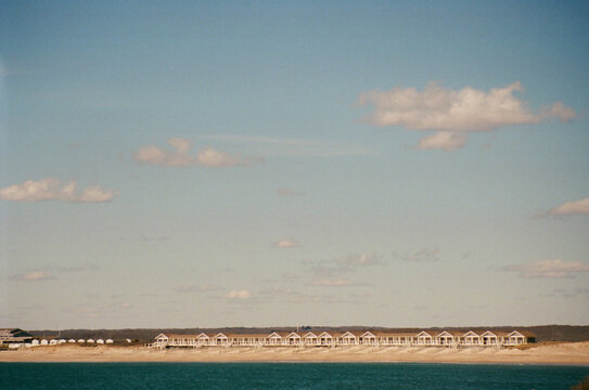 Beachfront cabins lined up along the ocean