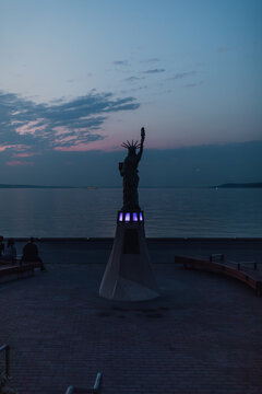 statue of liberty replica in West Seattle at night