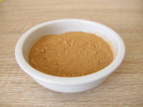 Low-histamine carob powder from the pods of the carob tree in a small porcelain bowl