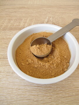 Low-histamine carob powder from the pods of the carob tree in a small porcelain bowl