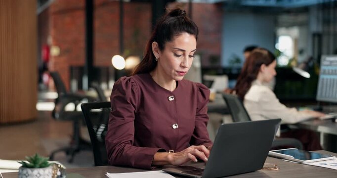 Laptop, woman and typing in office for article research, blog post review and editing story. Coworking, writer and mature person with proofreading project, creative process and planning with proposal