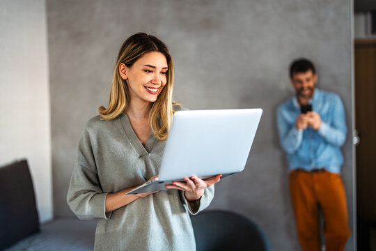 Young female influencer recording content from home, connecting her audience through social media