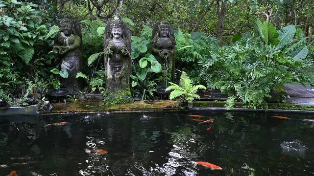 Stone figures pour water in Monkey Forest garden