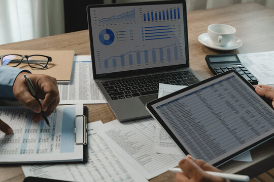 business discuss Investment Consultant, Financial advisor and accounting financial spreadsheets on tablet and laptop, reports support accounting review, report analysis document workflow.