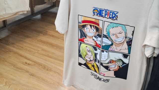 One Piece anime printed graphic casual t shirt featuring Straw Hat Crew characters hanging on clothing rack in retail store on July 24, 2026 in Bangkok, Thailand 