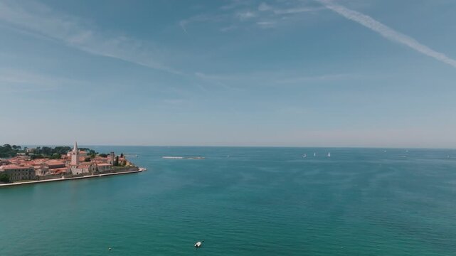 Aerial view of the historic old town of Porec with its stone buildings and bell tower overlooking the Adriatic Sea in Porec, Istria County, Croatia.