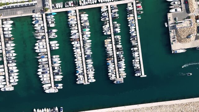 Aerial view of numerous boats docked in the marina of Moraira, Valencian Community, Spain.