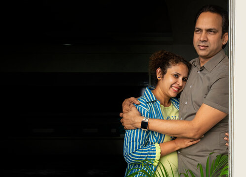 Young wife hugging her husband. 