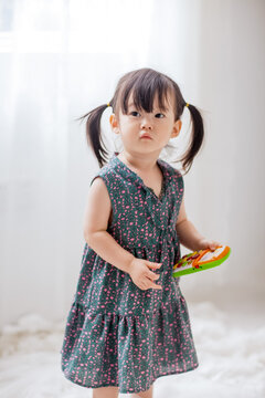 Cute Asian little girl playing indoors
