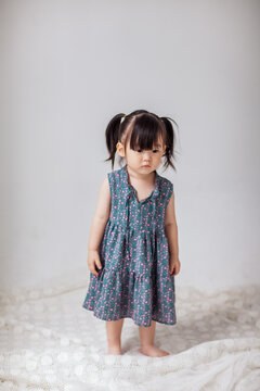 Cute Asian little girl playing indoors