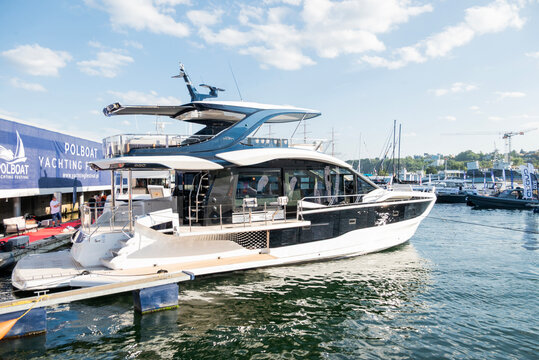  July 25, 2026, Gdynia, Poland,  Luxurious Galeon motor yacht docked at the marina during Polboat Yachting Festival in Gdynia. Sleek modern vessel moored on a sunny day with blue water reflections.
