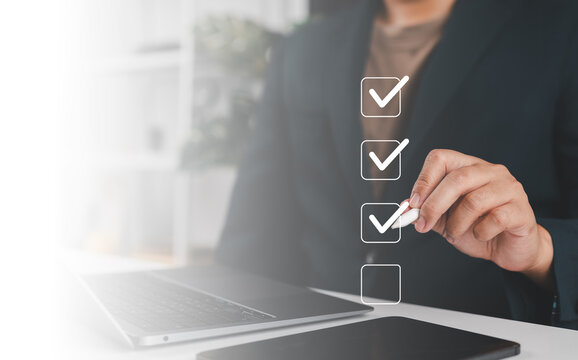 Businessman use pen to tick correct sign mark in checkbox for quality document control checklist and business approve project concept.
