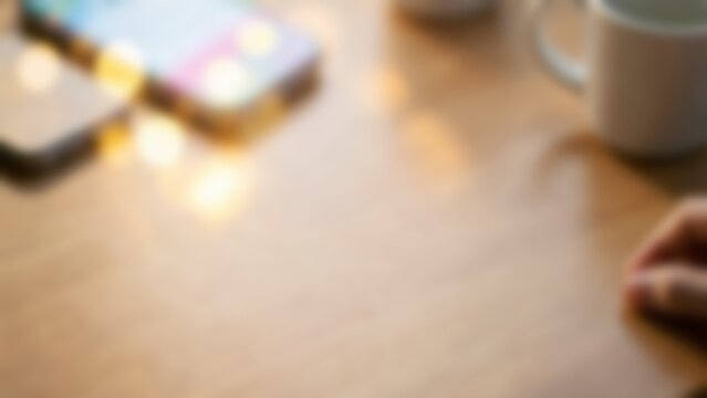 Blurred wooden desk with mobile phone for fintech app website banner