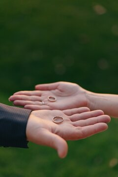 Bride Groom Holding Wedding Rings On Open Palms Detail