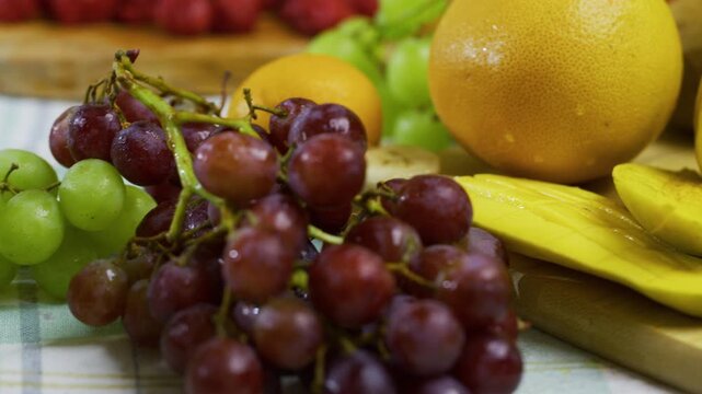 Smooth tracking, closeup shot across fresh fruit on kitchen counter
