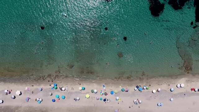Nea Poteidaia Beach with Colorful Umbrellas and Swimmers