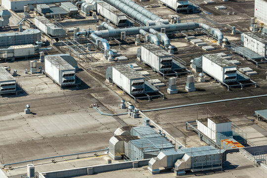 Aerial view of an advanced ventilation system with extensive ductwork and industrial HVAC units installed on the flat roof of a food factory in Poland.