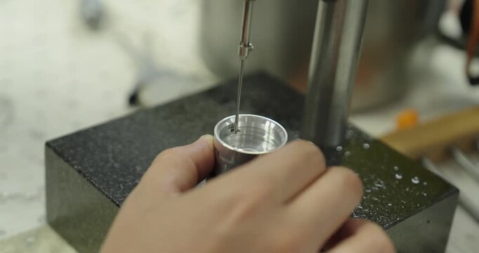 Precision measuring probe inspecting the inner dimensions of a machined metal component, demonstrating industrial metrology, quality control, and precision manufacturing.