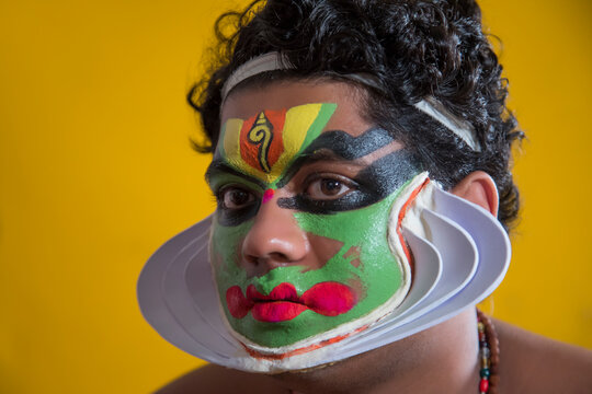 Kathakali dancer during his final stages of makeup. .