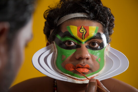 Kathakali dancer getting his final stages of makeup done.