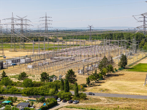 Aerial view of Amprion-Umspannwerk electrical substation with high-voltage power lines and towers surrounded by agricultural fields in Pfungstadt, Hessen, Germany.
