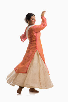 Graceful Kathak dancer giving a mesmerising performance in front of a white background. 